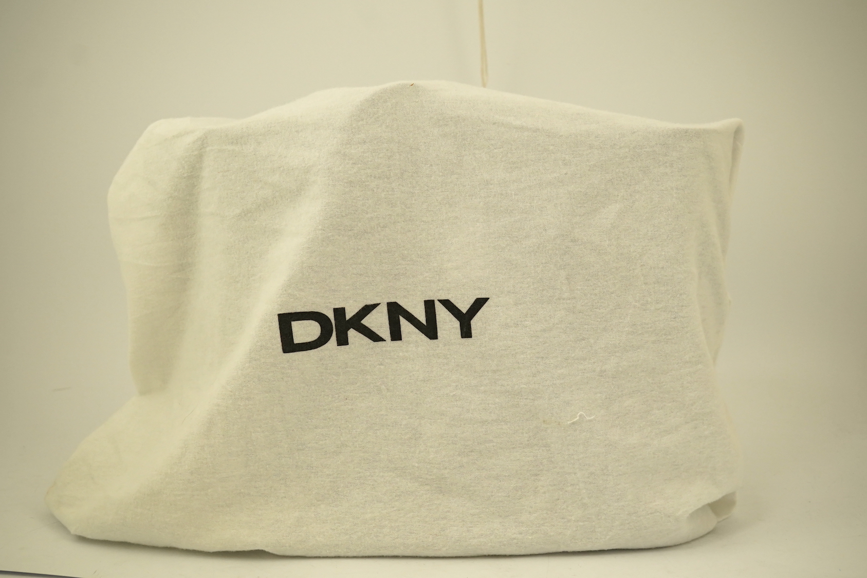 A DKNY black patient leather tote with scarf detail.